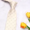 Close-up detail shot of a classic men's polka dot tie with textured chevron pattern. - Light Polka Dot (008)