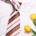 Detailed view of a stylish mens striped tie with brown, green, and beige diagonal stripes. - Brown Green Beige Bold Stripe (022)