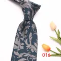 Detail view of a classic men's dark blue jacquard tie with elegant silver floral pattern. - 016 (Dark Blue Floral)