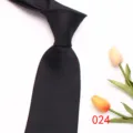 Detail view of black men's business necktie with red polka dots, elegant silk tie. - 024 (Black and Red Polka Dot)
