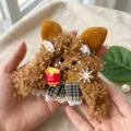 Handmade plush seed pod doll charm detail view showing cute furry design and mini fries toy. - Single Pod 1 Materials