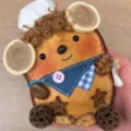 Handmade wooden animal figurine detail shot, rustic craft decor with pinecone and fabric accents. - Double Pea Pod 2 Little Chef