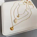 Collana multistrato dorata con deliziosi ciondoli a forma di stella marina e conchiglia. - #29 collana - dorata (set da 3 pezzi)