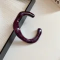 Close-up detail of dark purple acrylic irregular geometric open bangle, minimalist stylish jewelry. - Bracelet-Purple