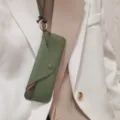 Detailaufnahme eines grünen Echtleder Brillenetuis mit Halsband und Metallring Aufbewahrung. - Dunkelgrün
