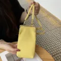 Yellow genuine leather kiss-lock phone bag, stylish mini crossbody shoulder bag for women. - Yellow