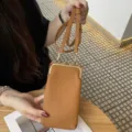 Brown leather mini phone bag with kiss-lock closure and slim crossbody strap for women. - Earthy Yellow