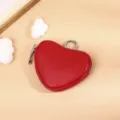 Red heart shaped leather coin purse detail shot with metal zipper and ring for small items. - Bright Red