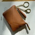 Brown leather coin purse with keychain and wrist strap, compact mini wallet for women. - Caramel color