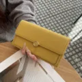 Yellow leather long wallet for women, classic flap design with metal flower snap closure. - Yellow