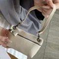 Compact genuine leather mini coin purse featuring zipper closure and short strap style. - Off White