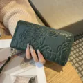 Green genuine leather long zip wallet with embossed camellia flower pattern for women. - Green