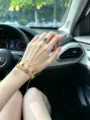 Gold-tone slave bracelet with blue gemstone heart ring, elegant hand chain jewelry for women. - Gold