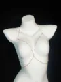 Detailed close-up view of a delicate gold-toned body chain with sparkling pink crystal beads. - Geometric Pink Rhinestone Body Chain (Rose Gold)
