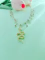 Detailed view of trendy gold layered anklet featuring snake pendant and cute bow charms. - Gold