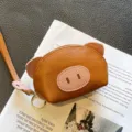 Cute mini leather coin purse with pig design, compact size, portable wrist strap key chain. - Earthy Yellow