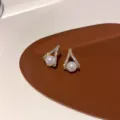 Close-up detail of geometric rhinestone pearl stud earrings, featuring elegant daily wear design. - Triangular Teardrop Silver Post Earrings - No. 108