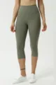 Nahaufnahme von Damen High-Waist Capri Yogahosen, weicher, angerauter Stoff, bequeme Passform. - Moosgrün