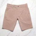 Men's casual quick-dry solid color beach shorts detail view, showing elastic fabric and buttons. - Size 30 / Light Peach