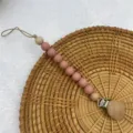Silicone wooden baby pacifier clip teething chain detail view, safe secure infant soothing accessory - Blush