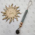 Silicone pacifier clip detail view, grey beads with wooden accents and metal clip. - Dark Green Abacus Beads
