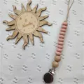 Close-up detail of silicone pacifier clip with wooden beads and secure stainless steel clip. - Pink Abacus Bead