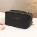 Black PU leather cosmetic bag with top handle, multi-layer travel toiletry storage pouch. - Black