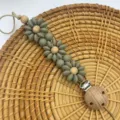 Sage green silicone flower baby pacifier clip featuring natural wooden beads soothing chain - Bean Green