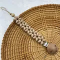 Silicone flower baby pacifier clip variant in nude color with wooden beads and secure metal clasp. - Khaki Flat Beads