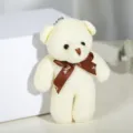 Vista detallada del lindo mini llavero de oso de peluche crema con cinta marrón - 12cm / Blanco Roto