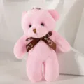 Close-up detail showing a small pink plush bear keychain with a brown Love ribbon bow. - 12cm / Pink