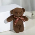 Close-up of a brown plush teddy bear keychain with a decorative LOVE ribbon bow - 12cm / Coffee
