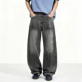 Men's loose washed baggy denim jeans with curved legs, metal buckle closure and paint splatter. - S / Black