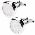 Close-up detail of silver men letter G round metal cufflinks with polished finish. - Letter G