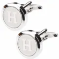 Detailed close-up view of silver-toned round men shirt letter H metal cufflinks. - Letter H