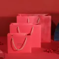 Red paper gift bags with handles, thick wedding favor bags, festive packaging for celebration. - Gold Stamped Gift Bag / 35x28.5x13cm