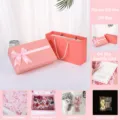 Pink bow gift box set with paper bag, raffia, miniature bouquet, plush rabbit and fairy lights. - Gift Box + Gift Bag + Raffia + Card + Bouquet + String Lights + Rabbit