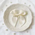 Dettaglio elegante fiocco in nastro di raso crema, perfetto per decorare scatole regalo. - 4x42.5cm / Bianco Latte