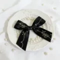 Black satin ribbon bow with gold stamping happy text detail shot for gift box decoration. - Black Hot Stamping Approx 2.5x36cm