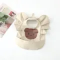 Waterproof baby bib with ruffles and cute bear print, PU dining apron for toddlers and kids. - Placed Print Big Face Bear Wings