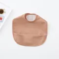 Waterproof baby PU bib with crumb catcher pocket, soft and easy to clean feeding accessory. - Solid Copper Red