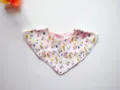 Baby cotton triangle bib detail, floral print fabric close-up, soft and skin-friendly texture. - Flower