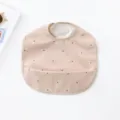 Waterproof baby PU bib with cute polka dot pattern, soft material for easy cleaning dining time. - Pink Base Black Dot