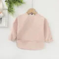Babero impermeable de manga larga en rosa claro para bebés, ideal para comer y jugar sin manchas. - Rosa liso