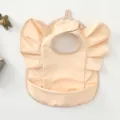 Waterproof PU baby bib with cute angel wings ruffles and crumb catcher pocket for feeding time - Dusty Pink Wings Style