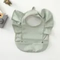 Waterproof baby bib with cute angel wings and crumb catcher pocket, minimalist light green design. - Solid Green Wings Style