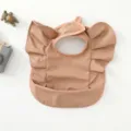 Waterproof baby bib detail shot, PU material, cute angel wings design, ideal for feeding. - Copper Red Wings Style