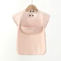 Detailed view of waterproof baby PU bib, short sleeve feeding coverall in soft pink color. - S / Pink