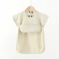Detail view of the soft PU baby eating bib short sleeve waterproof design for clean feeding. - Beige