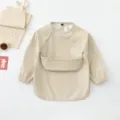 Beige waterproof baby long sleeve smock bib with pocket, ideal for toddler feeding time. - Size S for 6-12 Months / Beige